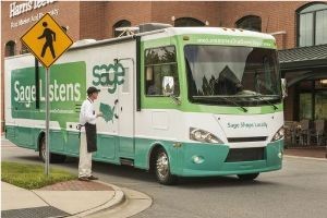 John Elliot, owner of Davidson Chocolate Co. in Davidson, N.C., and a Sage customer, meets Sage bus.