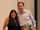 Chris Todd, the new CEO of UKG, is presented with a champion belt by Jennifer Brafman Staffen of UKG Corporate Communications during a June 2022 Analyst Relations event in Fort Lauderdale, FL