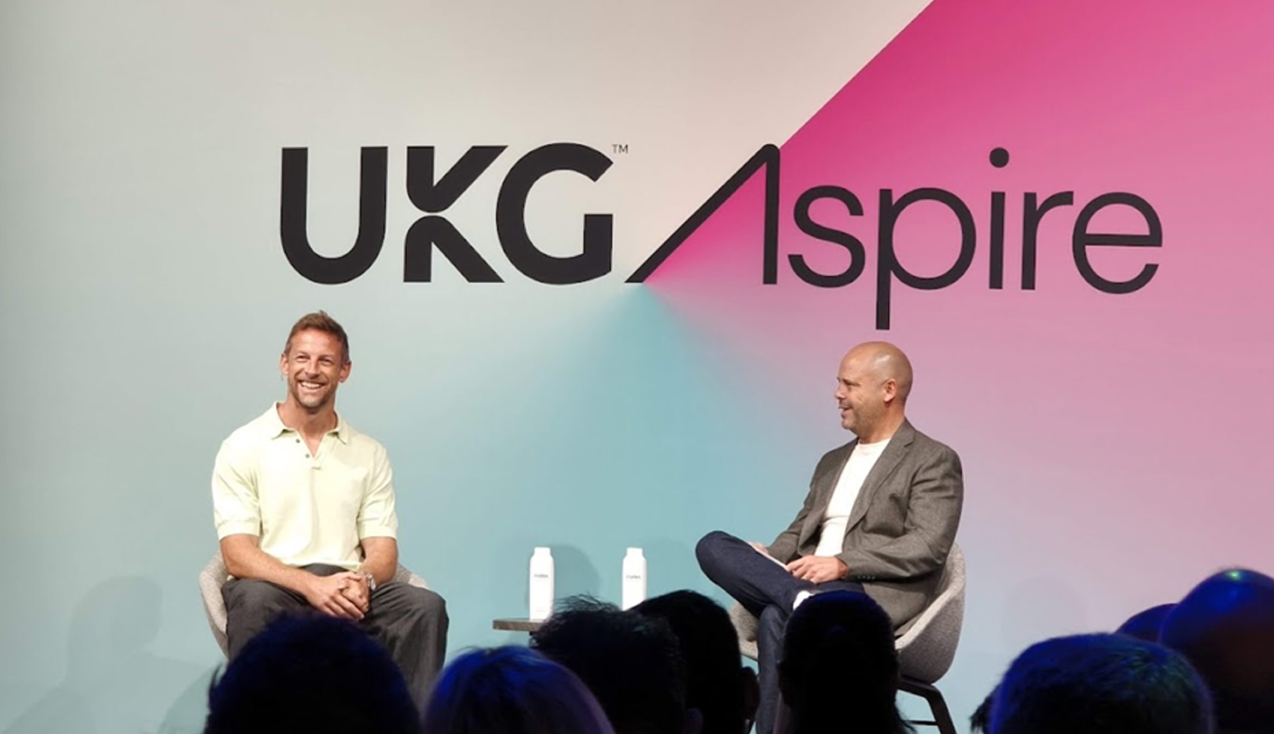 F1 World Champion Jenson Button joins Russell Howe, UKG’s GVP EMEA, on stage at UKG Aspire in London
